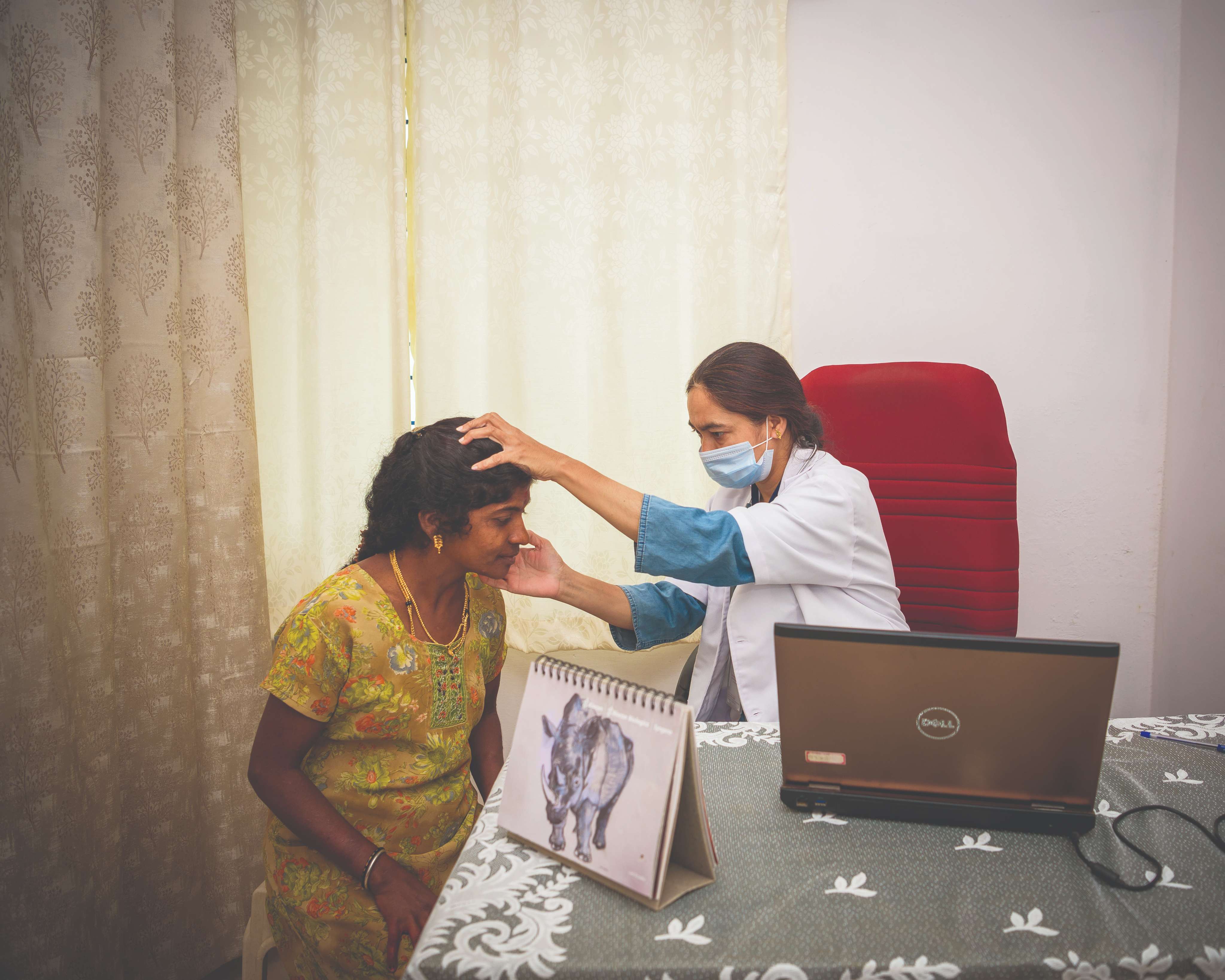 A doctor examining a patient at a Syngene eLAJ Smart Clinic